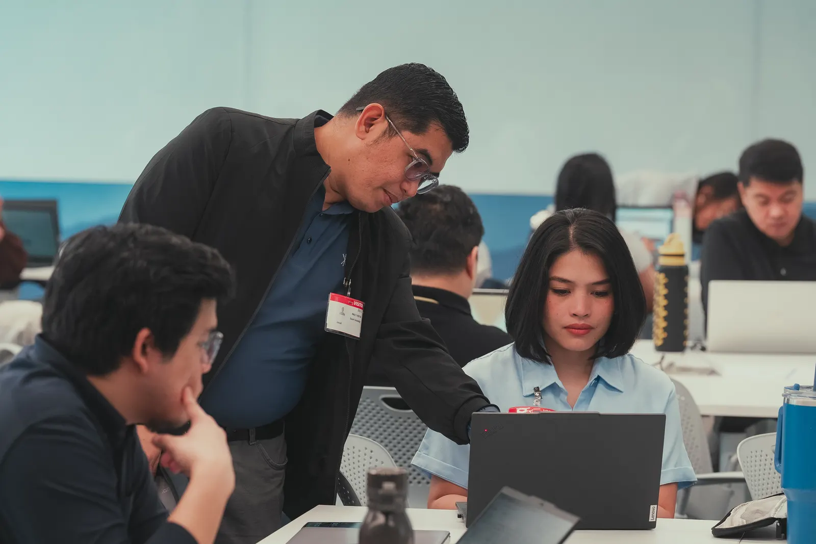 Swarm engineer coaching Aboitiz Foods staff at their laptops